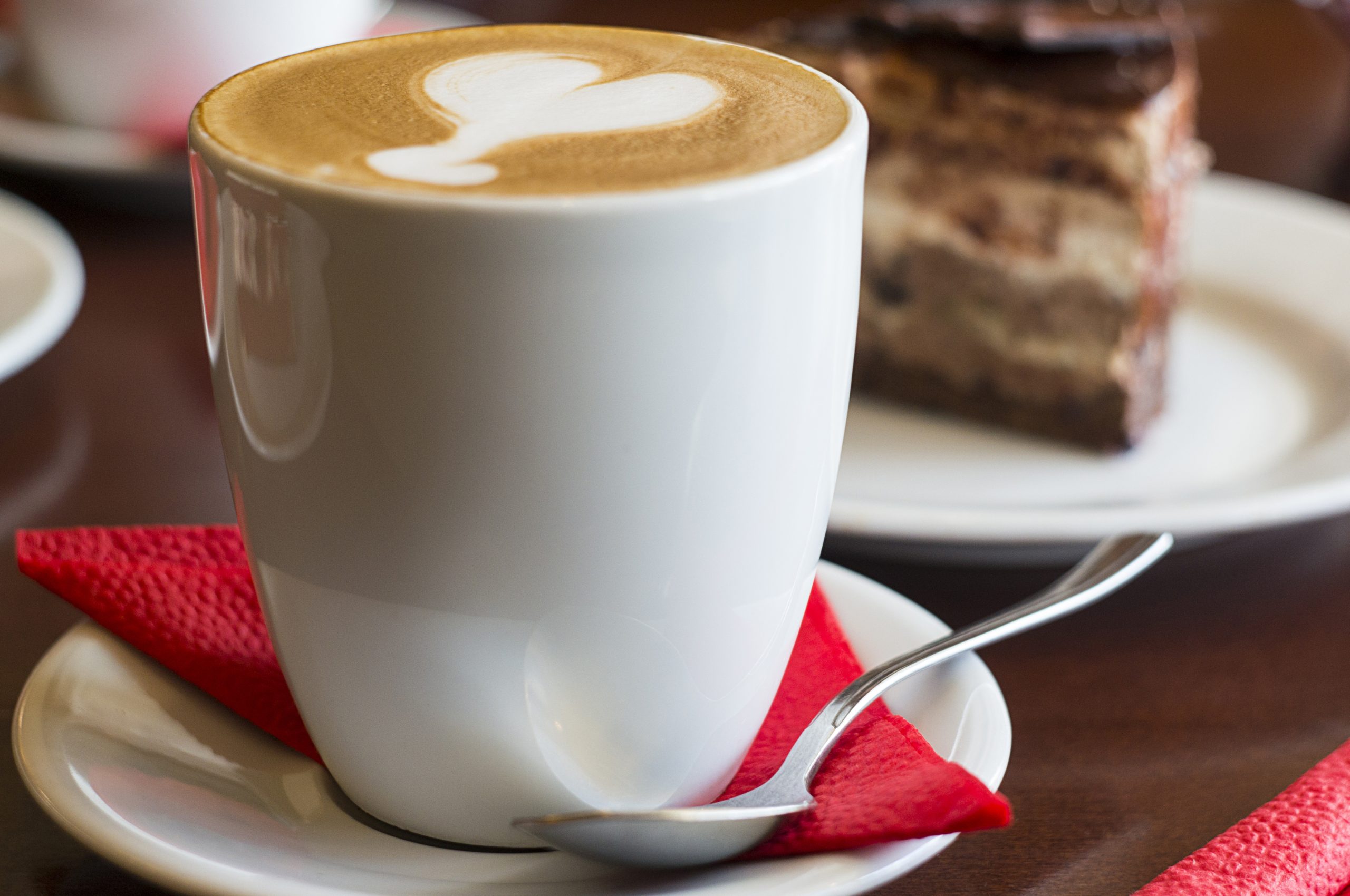 Cup of coffee with foam in the shape of a heart on top.